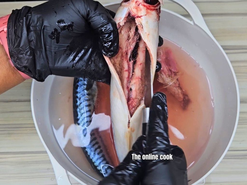 Scrapping blood clot from fish belly