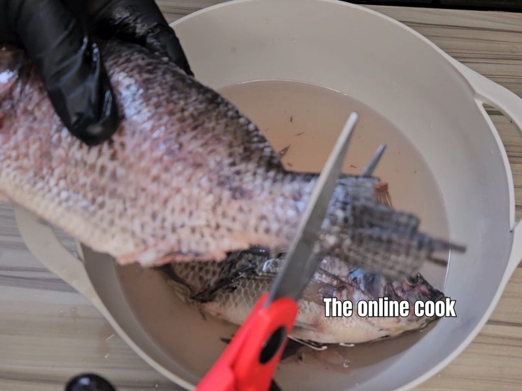 removing fins from whole tilapia fish